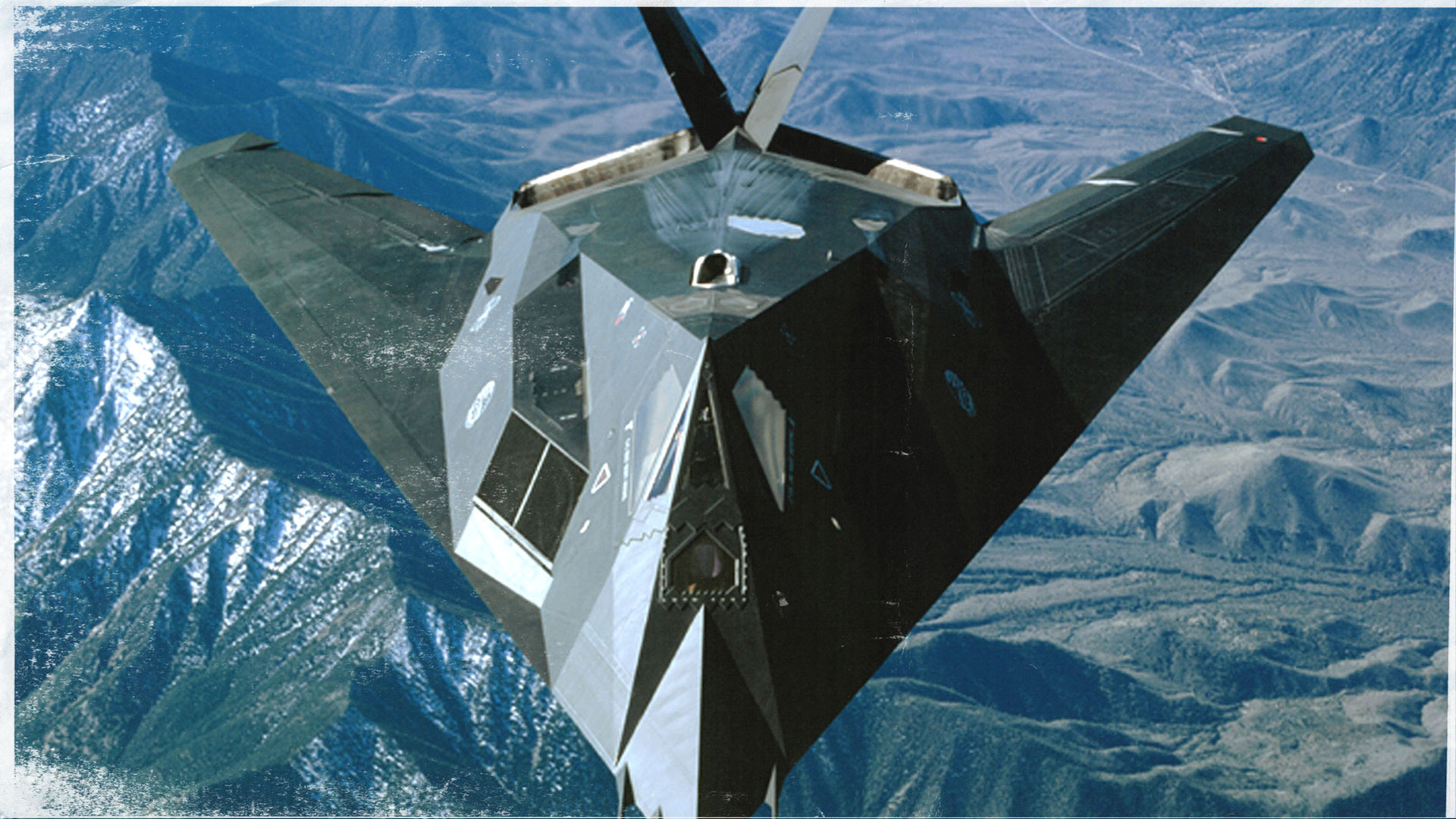 Close up of the stealth fighter flying over some mountains