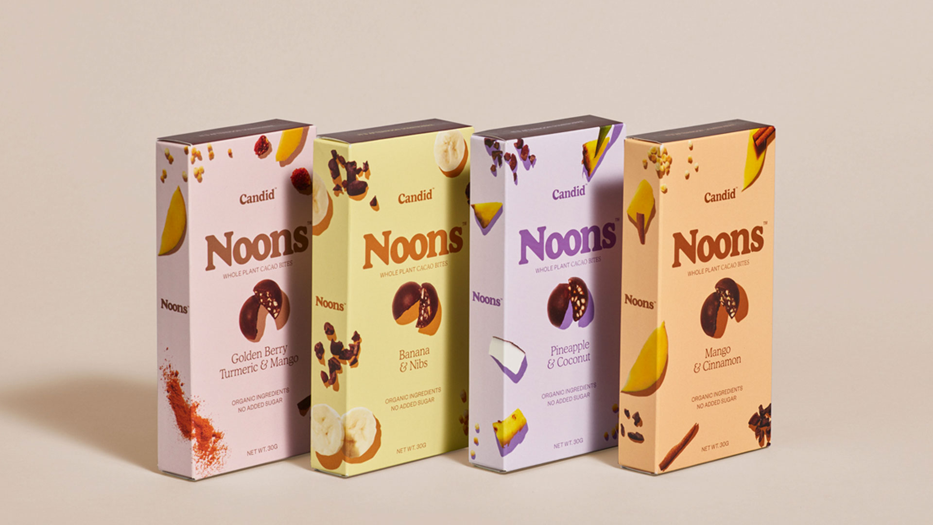 Four boxes of the flavors of Candid Noons stood up next to each other.